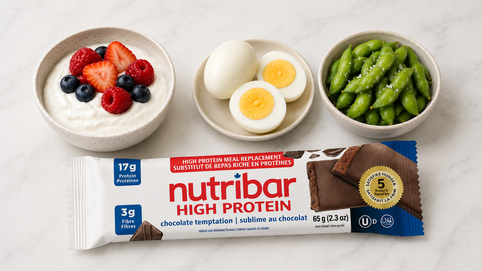 Greek yogurt, hard-boiled eggs, edamame and a Nutribar high-protein bar arranged as weight-loss snack options