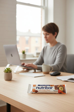 Person working at a desk with a Nutribar on the table