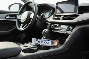 Car interior with a Nutribar package in the cup holder